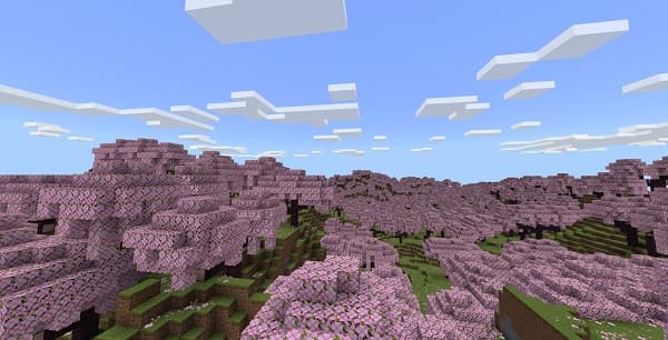 A black coffee mug rests on a light wooden table next to a steaming cup.