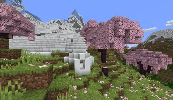 A large, modern building with many windows, reflecting the sky.