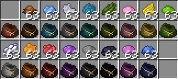 A cute domestic cat grooming itself on a blanket.