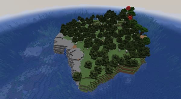 A person’s hand holds a small glass jar filled with green cannabis buds.