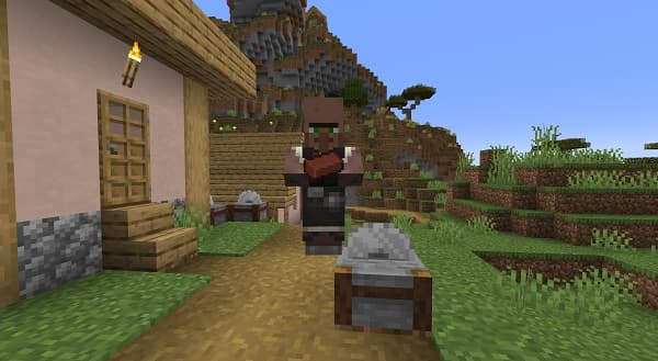 A person holding a small, brightly colored bird.