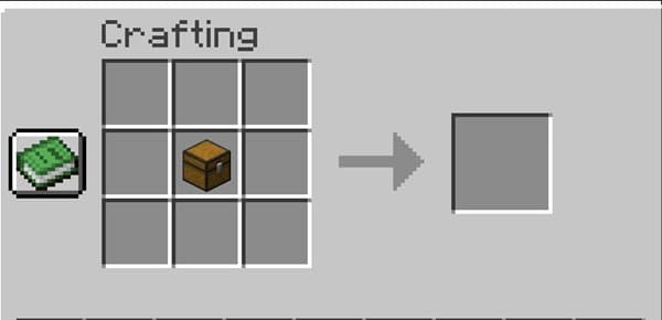 Young man smiling at laptop in modern office