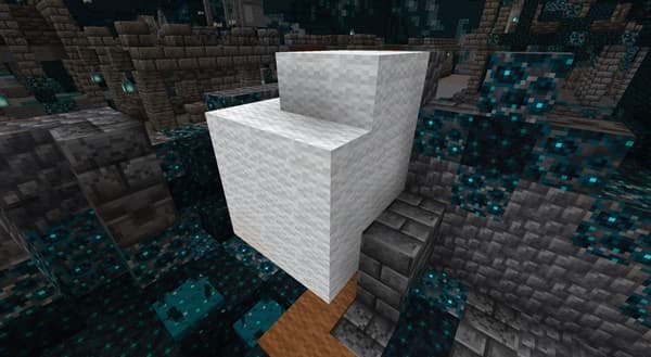 A sleek silver car with its driver's side door open, parked on an asphalt road.