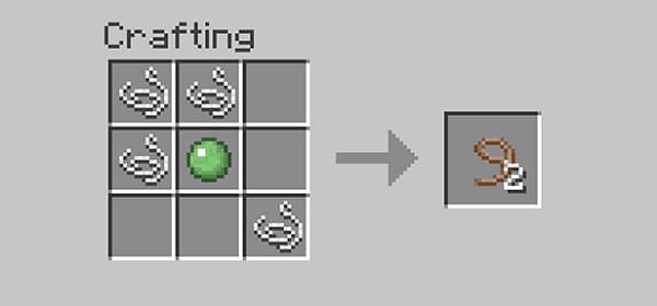 A lone, weathered tree stands on a grassy hill under a bright sky.