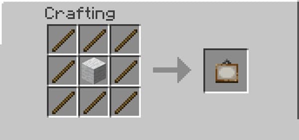 A person using a laptop and smartphone in a bright office.