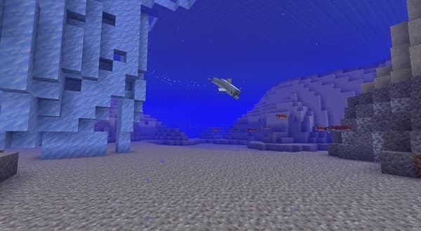 A person holding a small, brown bird gently in their cupped hands.