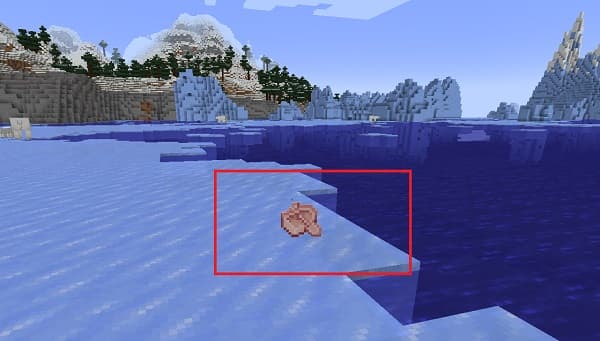 Young man in a dark hoodie with hands in pockets, looking thoughtful.