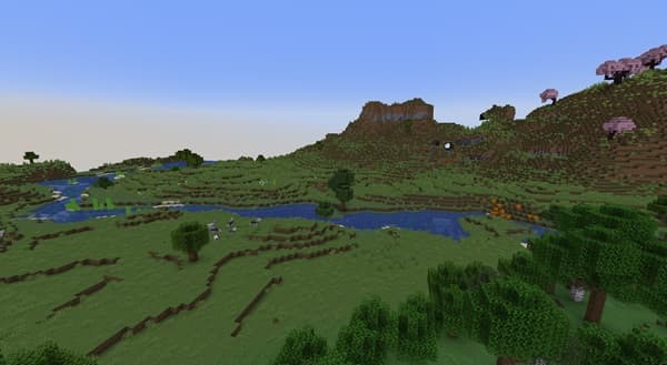 Woman smiling at a laptop while working from home.