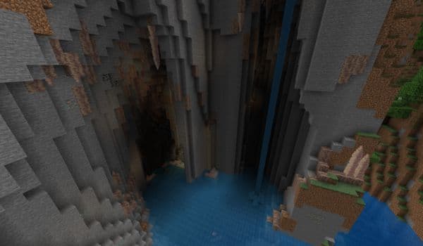 A modern white desk with a laptop, mouse, and a coffee mug.