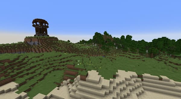 A white dog with brown ears and a red collar running through green grass.