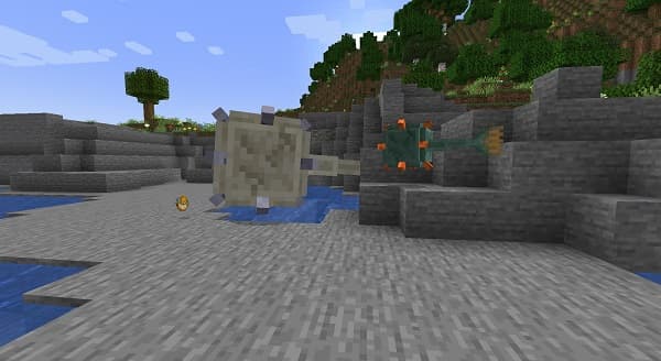 A young woman in a denim jacket and glasses smiles, holding a smartphone.