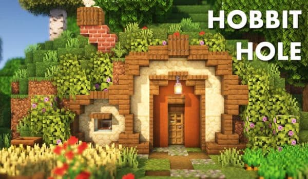 A small, fluffy white dog lying on a gray couch, looking up intently.