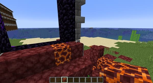 A small, clear glass vase with a single pink peony flower.