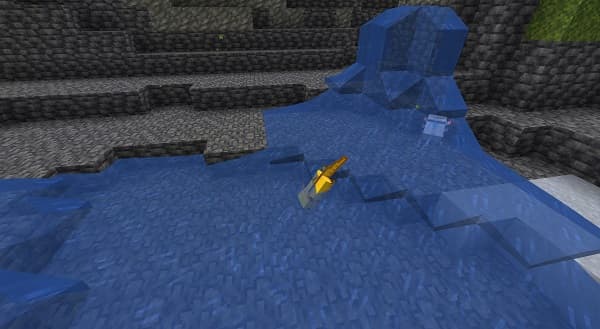 A serene, empty beach with white sand and clear blue water stretching to the horizon.