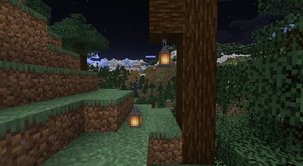 A person holding a small, empty, clear glass bottle with a cork stopper.