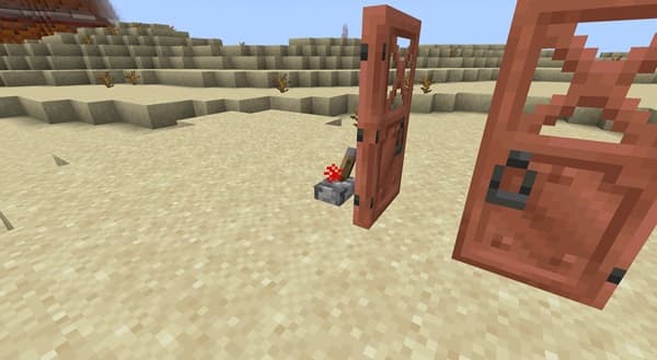 A lone, vibrant red poppy stands out in a green field under a clear blue sky.