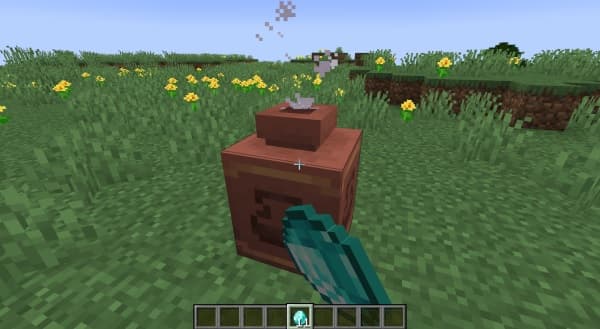 A picturesque, winding river flows through a vibrant green valley, surrounded by majestic mountains under a clear sky.