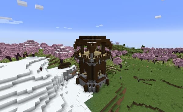 Empty office desk with a laptop and papers.