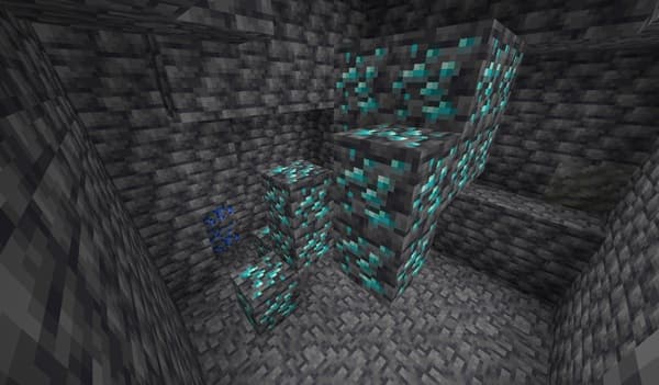 A black cat lying on a wooden floor, looking relaxed.