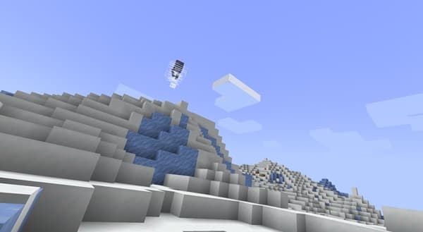 A person wearing an olive green beanie and sunglasses, with a subtle smile.