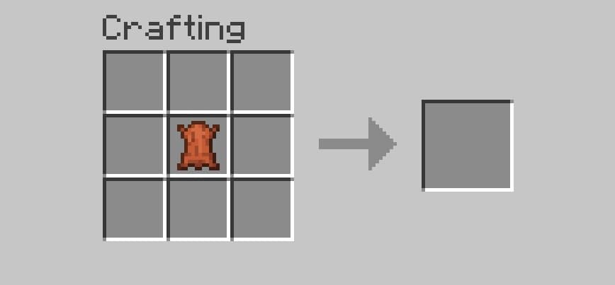 Modern minimalist living room with a gray sofa and warm lighting.