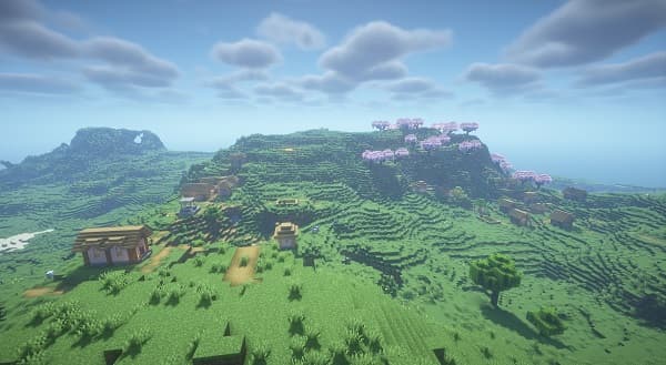 A sleek, modern white car parked on a dark, wet asphalt surface.