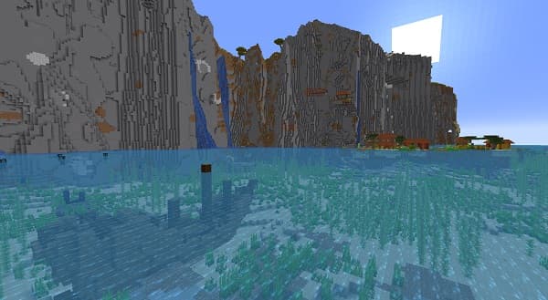 Young woman smiling and holding a pen, writing notes in a notebook.