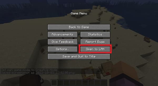 A person in a black shirt and jeans stands looking at a large, brightly lit Christmas tree in a room with a high ceiling.