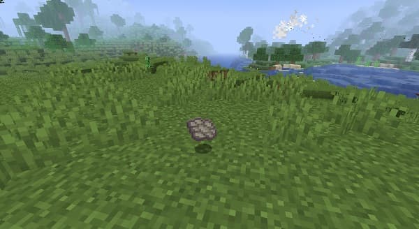 A person's hands holding a smartphone displaying a social media interface with various emojis.