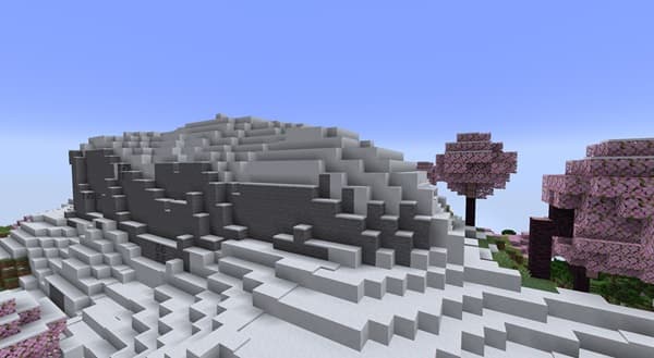 A person using a laptop on a desk, with a