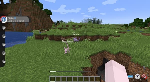 Black laptop on a wooden desk with a white notepad and pen next to it.