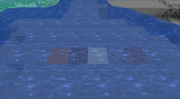 A black camera lens with an orange ring.