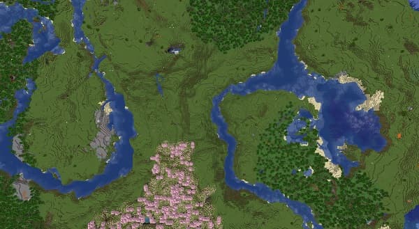 Two friends smiling while eating pizza and drinking beer at a restaurant.