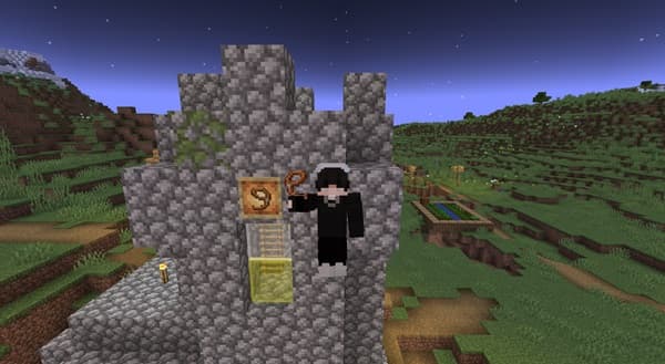 A black and white photo of a dark forest with tall trees.