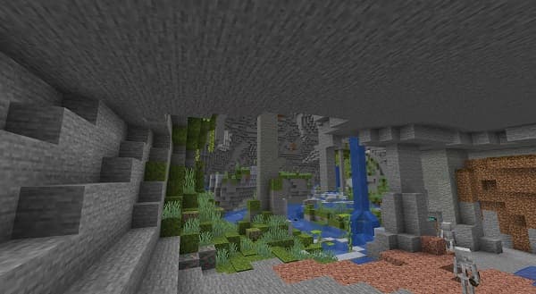 Empty office desk with a laptop and plant.