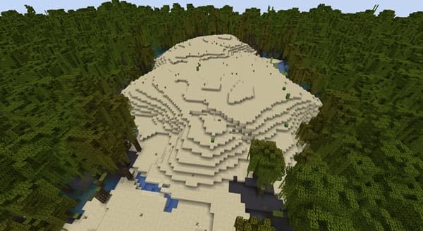 Person typing on a laptop with a modern office setup.