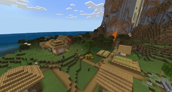 A person using a laptop and phone at a desk.