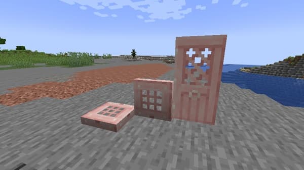 A young girl smiles while holding a baby doll.