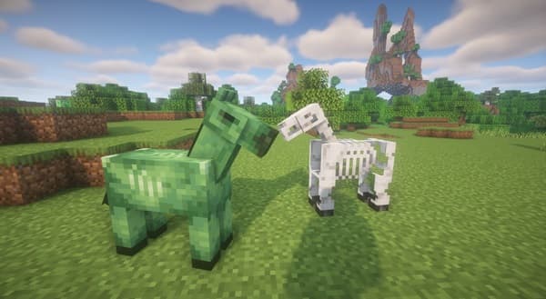 Two women sharing a laugh while working on a laptop.