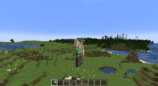 A person sitting on a sofa, looking at a smartphone.