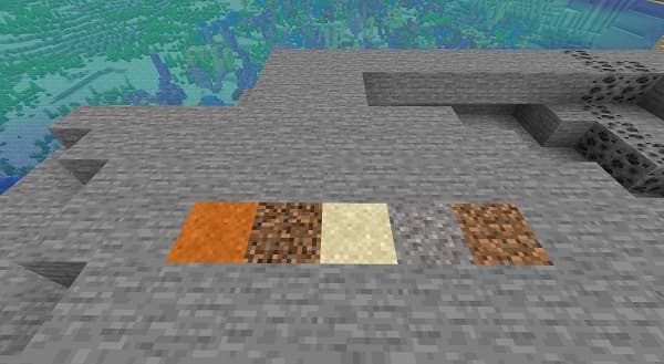 A black cat lying on a white bed.