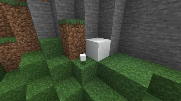 An empty white room with light brown hardwood floors and white walls.