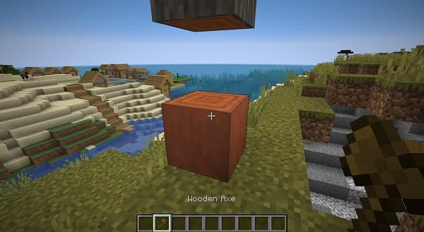 Alt text: Woman holding a smartphone displaying a social media feed with various posts and images.