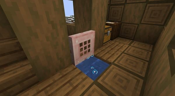 Red and green bell peppers on a white cutting board.