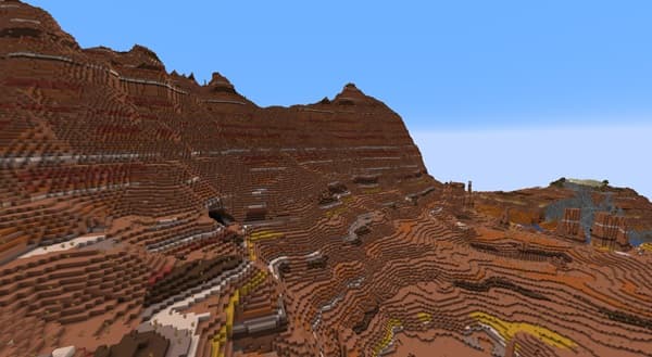 Empty room with white walls and a light brown wooden floor.