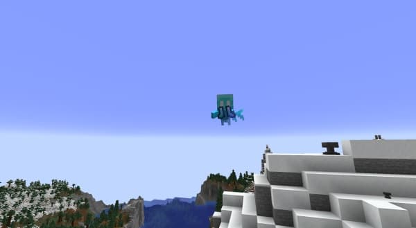 A serene mountain landscape with a clear lake and lush green trees.