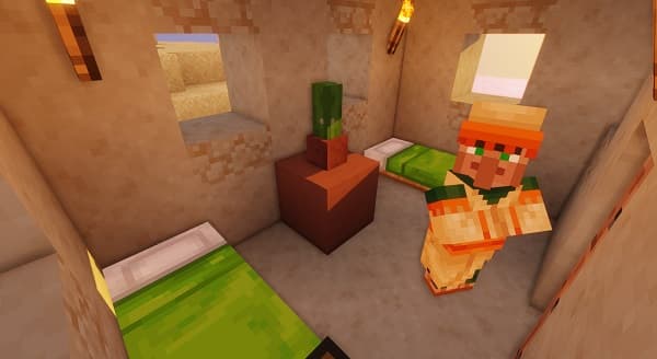 A serene, empty beach with white sand and clear blue water, bathed in sunlight.