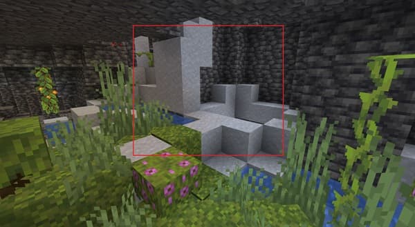 A person's hand typing on a laptop keyboard.