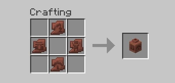 Red and white striped beach umbrella against a blue sky.