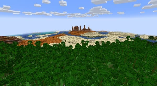 Empty office desk with a white laptop and green plant.